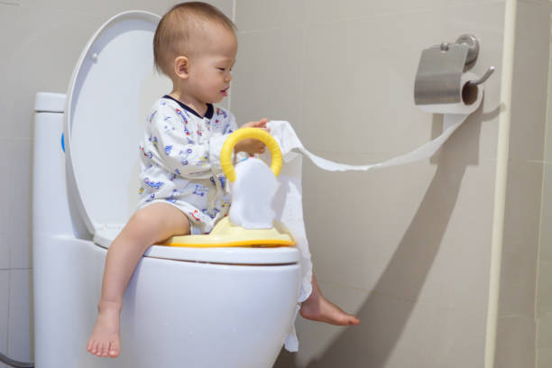 asian toddler boy  sitting on the toilet - people purity personal accessory handkerchief imagens e fotografias de stock