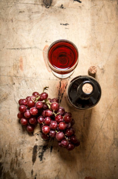 istock Bunch red grapes with a bottle of wine. 838007386