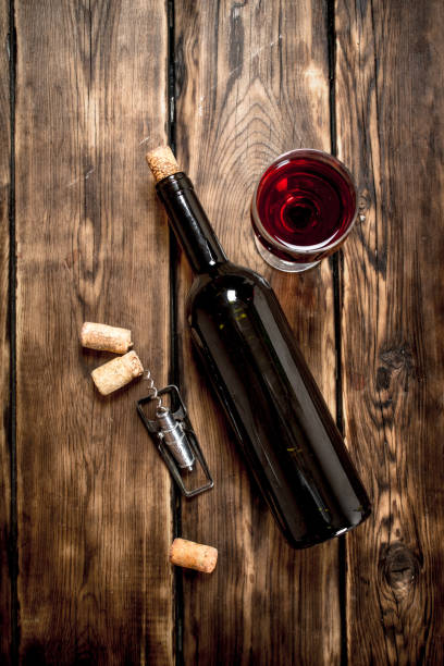 istock Bottle of red wine with a corkscrew and corks. 838008290