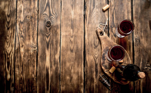 istock Red wine on wooden Board with stoppers and a corkscrew. 838008306