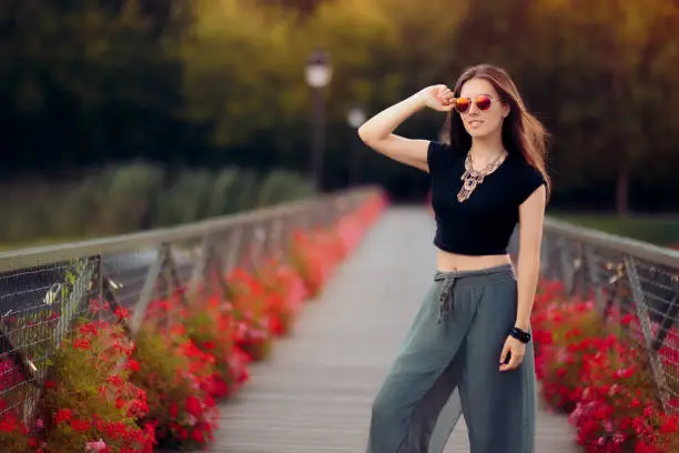 Beautiful girl wearing ethnic necklace and trousers outdoors