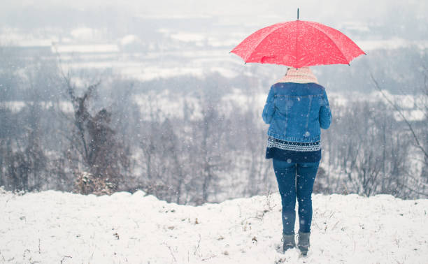 istock Girl holding red umbrella 838012622