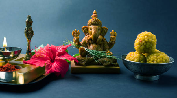 Happy Ganesh Chaturthi Greeting Card showing photograph of lord ganesha idol, pooja or puja thali, bundi laddu/modak, durva and hibiscus or jasvand flower stock photo