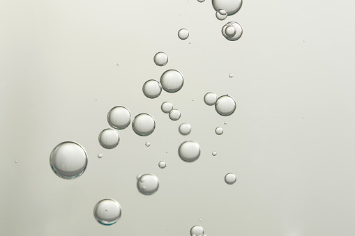 Flowing air bubbles over a blurred background