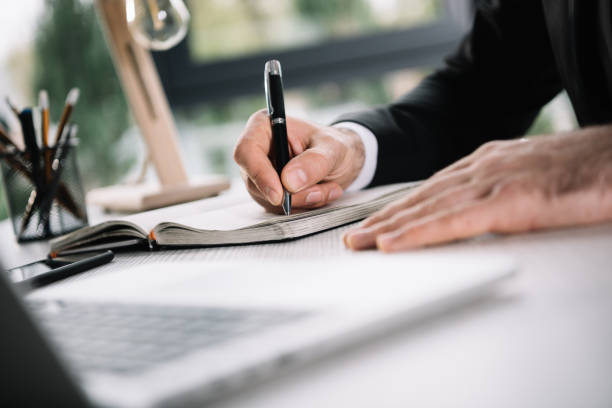 istock cropped shot of businessman writing in notebook 838024366