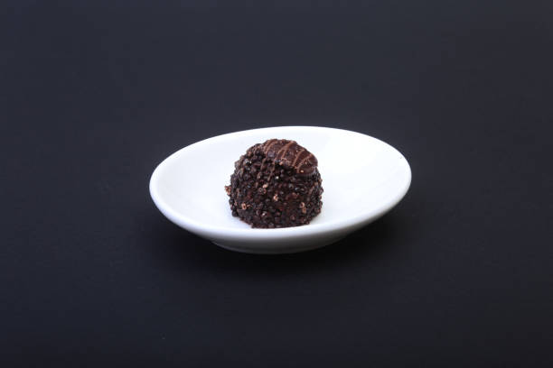 istock delicacy handmade chocolate pralines on white saucer. 838028068
