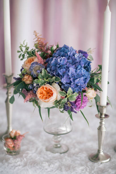 istock flower bouquet in vade with candles on the white decorated table 838028416