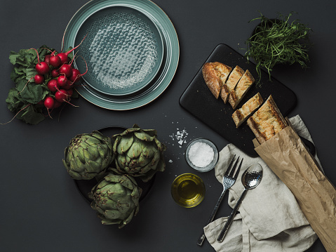 Food table setting with artichoke bread oils and salt