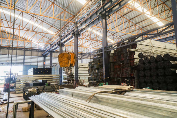 istock lifting crane with yellow hook in steel pipe warehouse 838029246