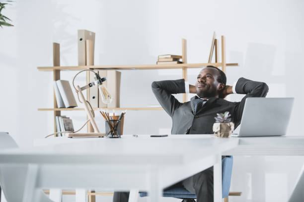 istock relaxed young afro businessman with hands behind head 838033610