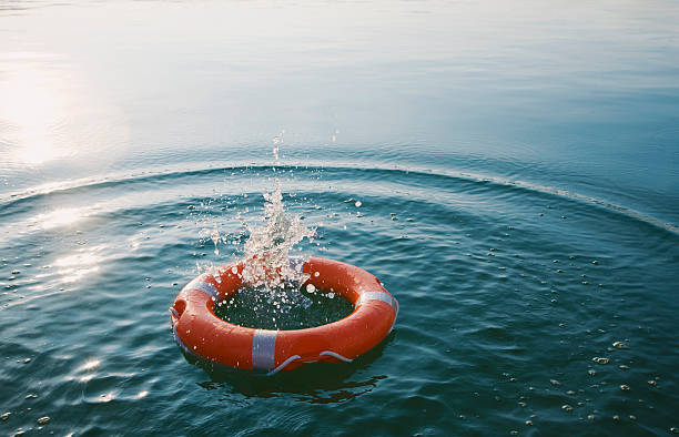 red life-ring with splash  - floating device zdjęcia i obrazy z banku zdjęć