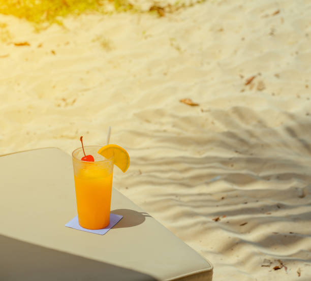 istock orange juice drink on the beach table, summer fresh cool water for relaxation, copy space. 838036114