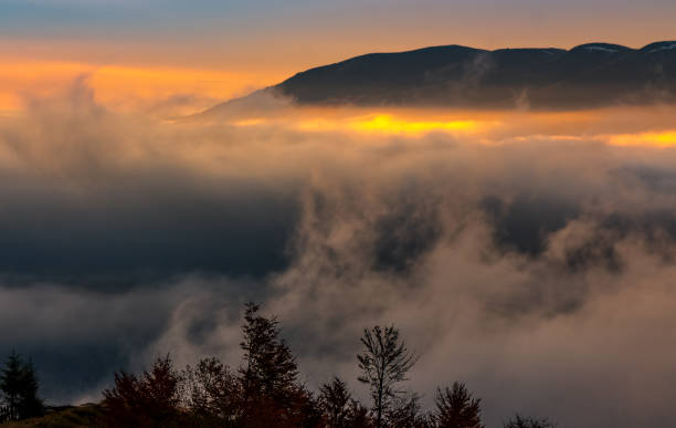 istock fog rise in mountains at sunrise 838036512
