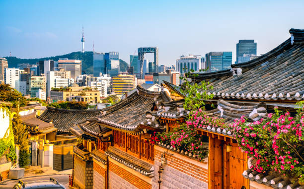 Bukchon Hanok Village with modern building in Seoul, South Korea Bukchon Hanok Village in Seoul, South Korea seoul province stock pictures, royalty-free photos & images