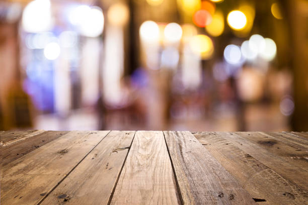 istock Empty wooden table with defocused street lights at background 838041330