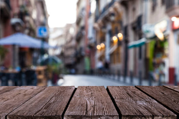 istock Empty wooden table with defocused street at background 838041332