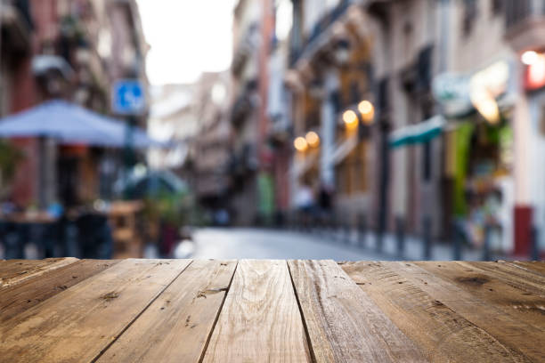 istock Empty wooden table with defocused street at background 838044112