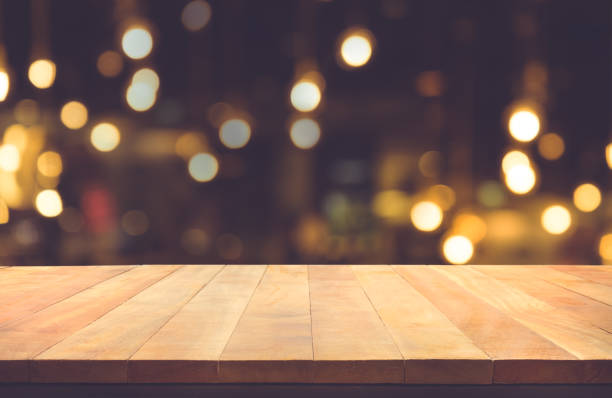 istock Wood table with blur light in night cafe,restaurant background 838044192