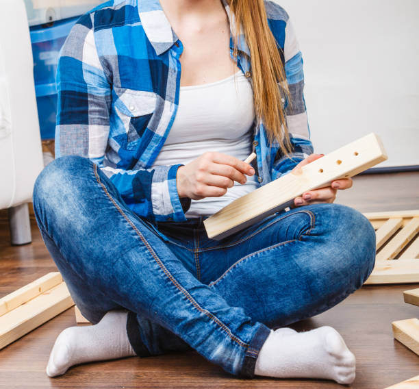 istock Woman assembling wood furniture. DIY. 838044376