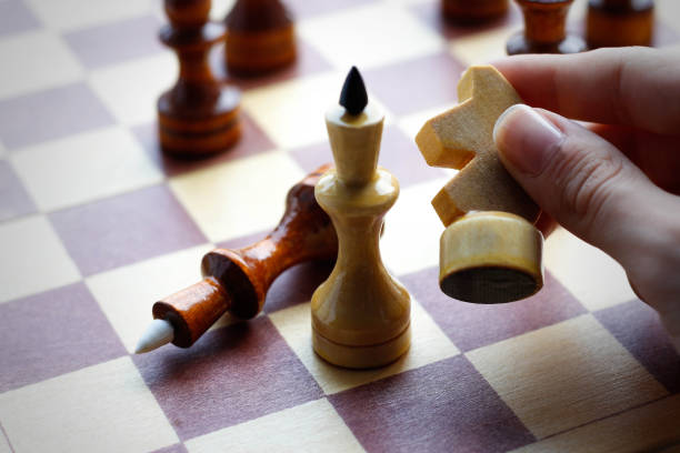 istock Hand holding wooden chess set on chess Board. Chess. Black and white. Closeup 838044456