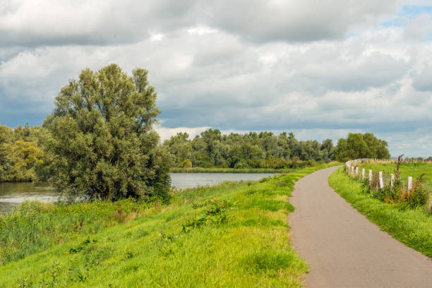 istock Narrow curved path on top of a dike 838045248