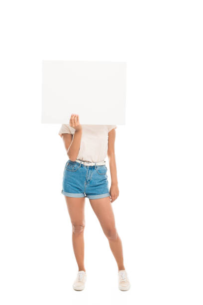 istock 'Attractive woman hiding face by blank banner, isolated on white 838047978