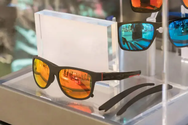 Photo of Various of sun glasses in the shop display shelves.