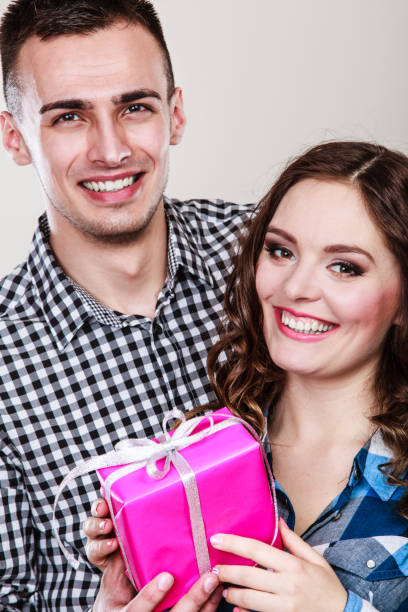 istock happy romantic couple with gift 838051394