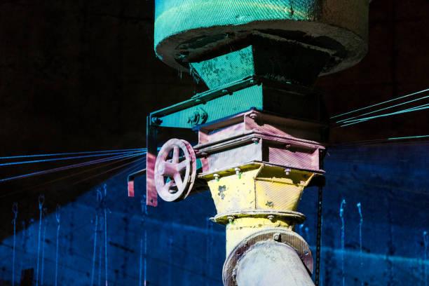 istock Old iron wheel on colored industrial pipe lines 838051548