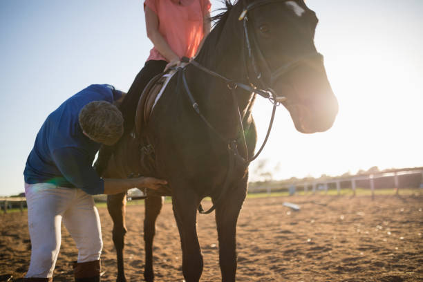 istock Male trainer adjusting woman leg on stirrup 838059352