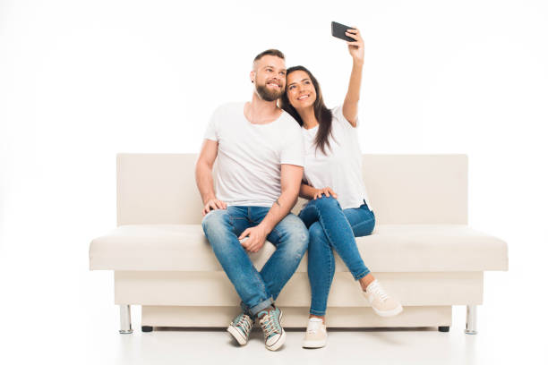 istock 'Young happy couple taking selfie by smartphone, isolated on white 838062764