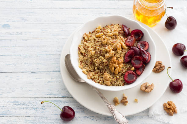 istock Quinoa with fresh cherries, walnuts and honey on the blue background 838063234