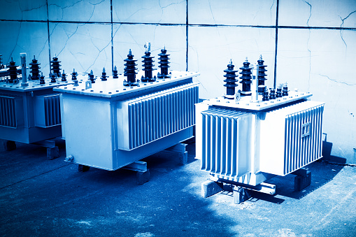 High voltage transformer with electrical insulation and electrical equipment in power substation.