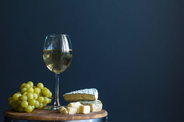 istock Glass with white wine and grapes near cheese composition 838064170