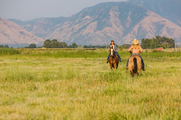 istock Women Riding Horses Across the Prairie 838070596