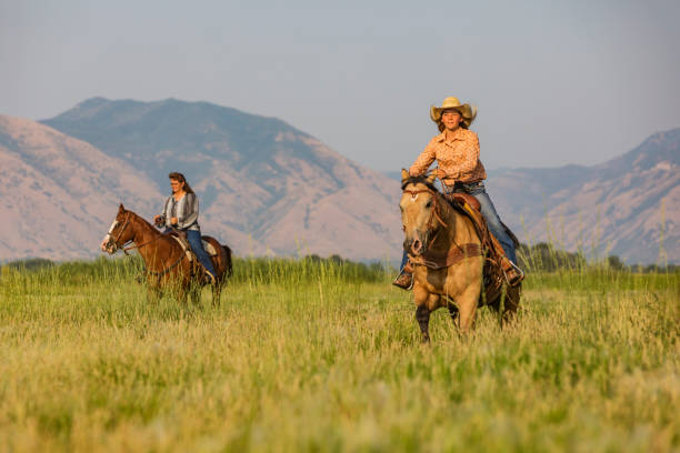 istock Women Riding Horses Across the Prairie 838070608