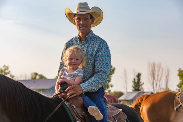 istock Cowboy Riding a Horse With His Young Daughter 838070648