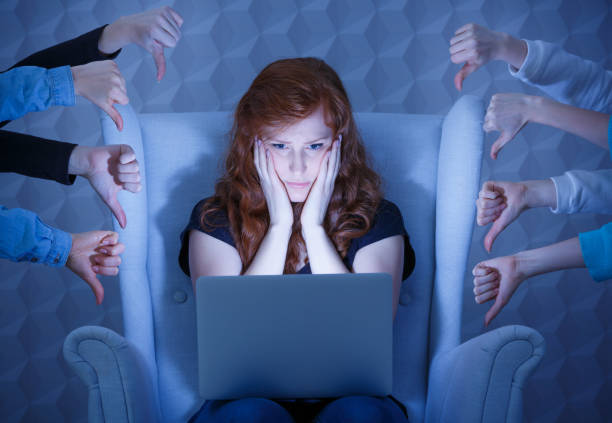 Negative comments on website Worried young woman having negative comments on her website cyberbullying stock pictures, royalty-free photos & images