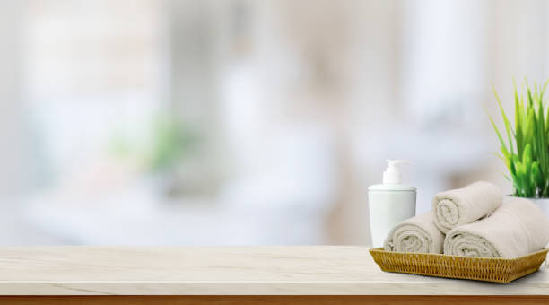 istock Towels in basket on top wood table with copy space on blurred bathroom background. 