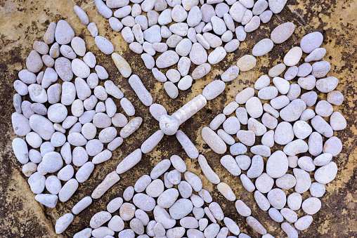 Compound of pebbles laid out in the form of a cross
