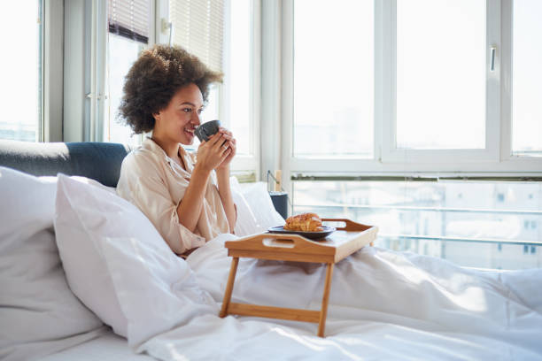 istock Woman drinking morning coffee in bed 838075244