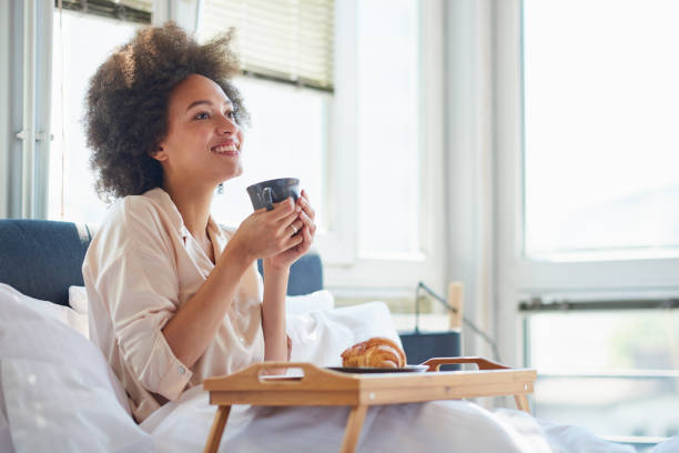 istock Woman drinking morning coffee in bed 838075318