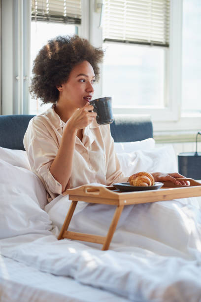 istock Woman drinking morning coffee in bed 838075380