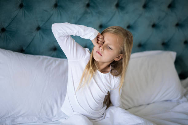istock Girl waking up on bed in bedroom 838078618