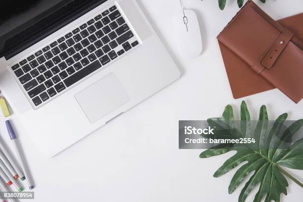 Designer Office Desk With Notebook And Computer Crayon Leaves Top View Table From Above With Flat Lay Stock Photo - Download Image Now