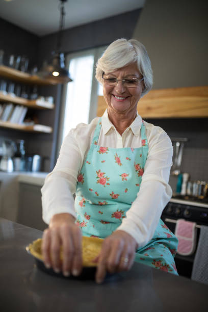 istock Senior woman having tart in kitchen 838079518