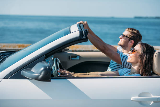 istock multicultural young couple riding car at seaside while traveling together 838081858