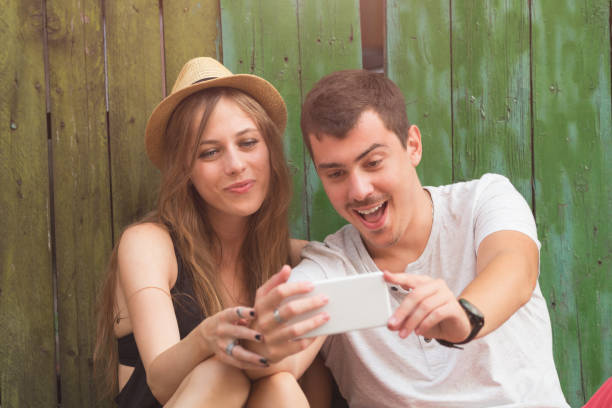 istock Couple in love using cellphone outdoors. 838083750