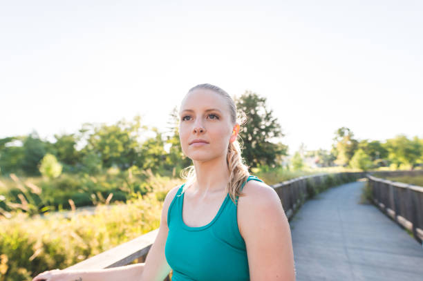 istock Young woman jogging outside 838089398
