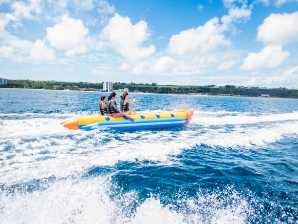 istock Three women riding a banana boat in guam 838095662
